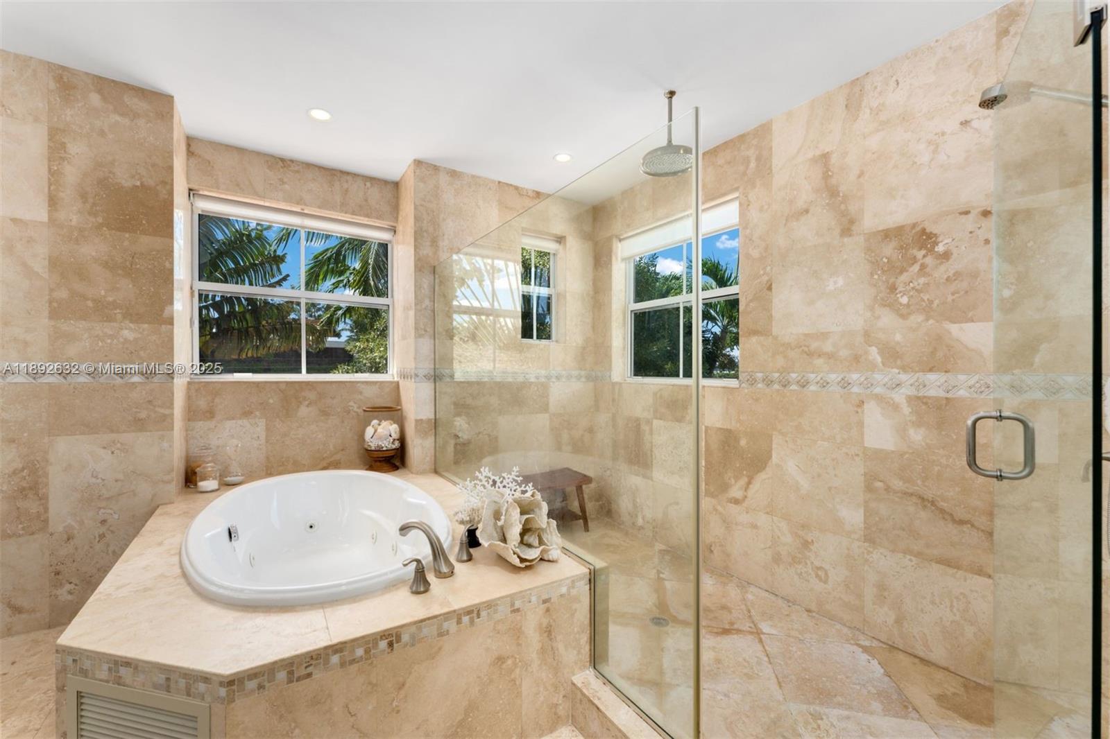 2143 North Bay Road Miami Beach, FL 33140 - Photo 25 of 39 a bathroom with a granite countertop sink and a bathtub