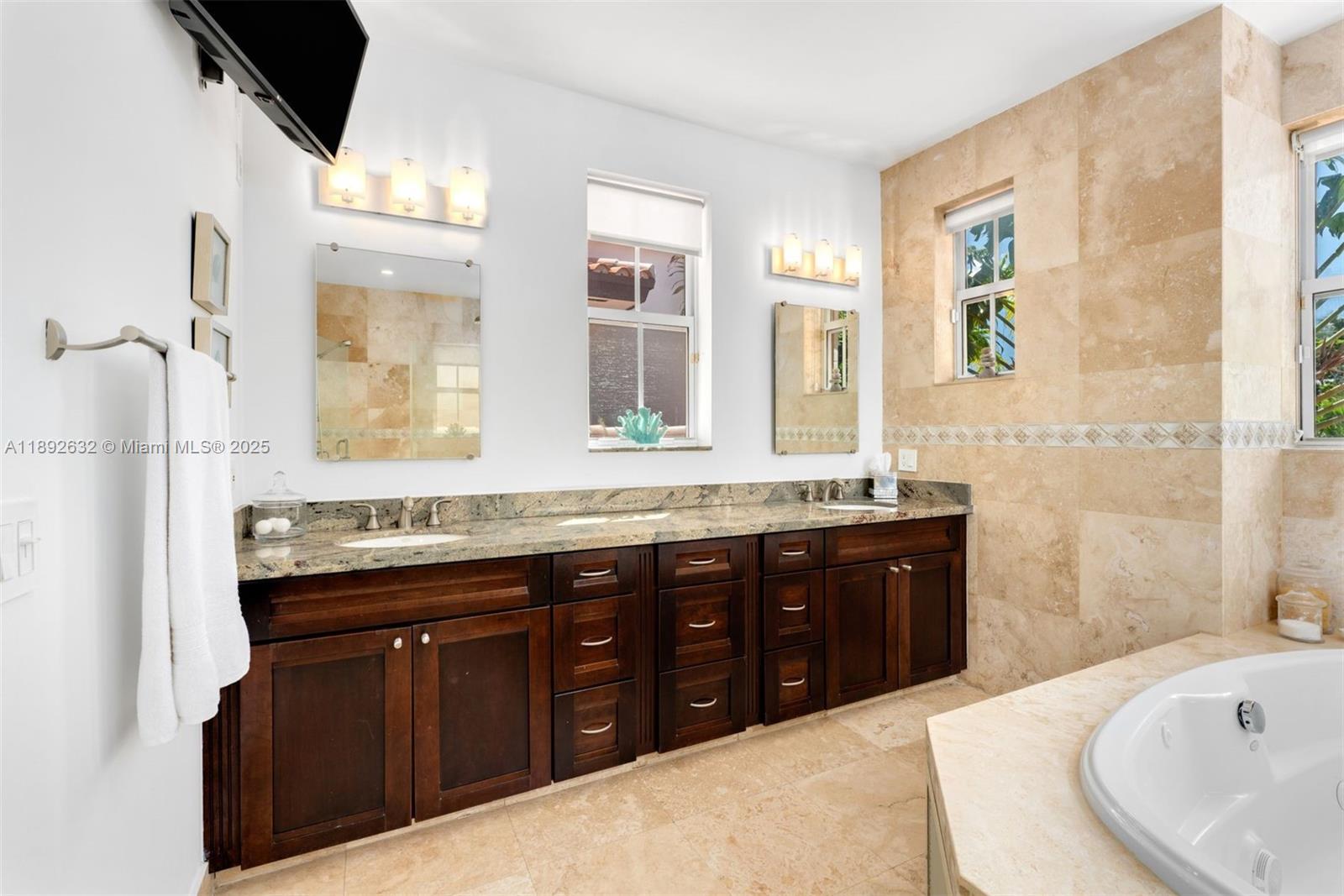 2143 North Bay Road Miami Beach, FL 33140 - Photo 26 of 39 a spacious bathroom with a tub sink and mirror