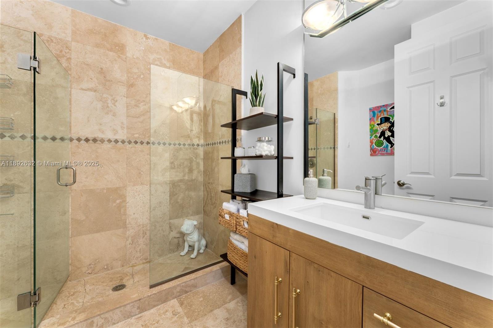 2143 North Bay Road Miami Beach, FL 33140 - Photo 28 of 39 a bathroom with a shower sink and mirror