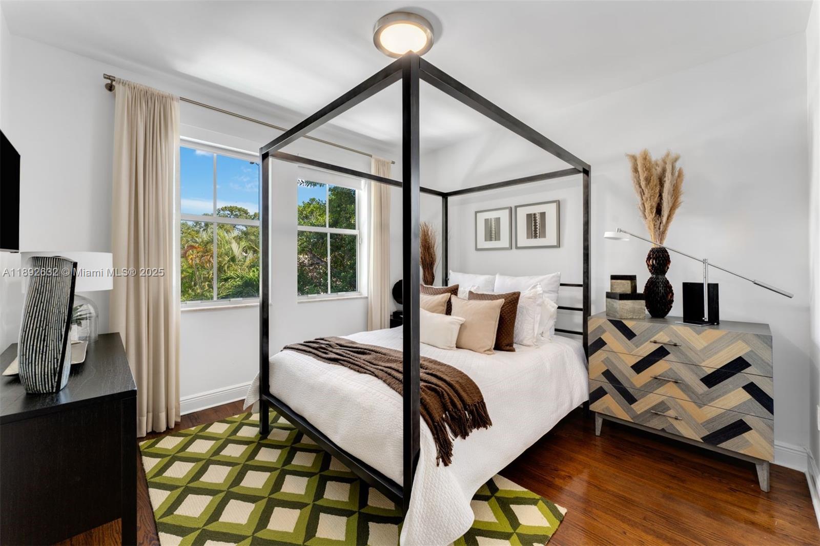 2143 North Bay Road Miami Beach, FL 33140 - Photo 29 of 39 a bedroom with a bed and a flat tv screen on a dresser