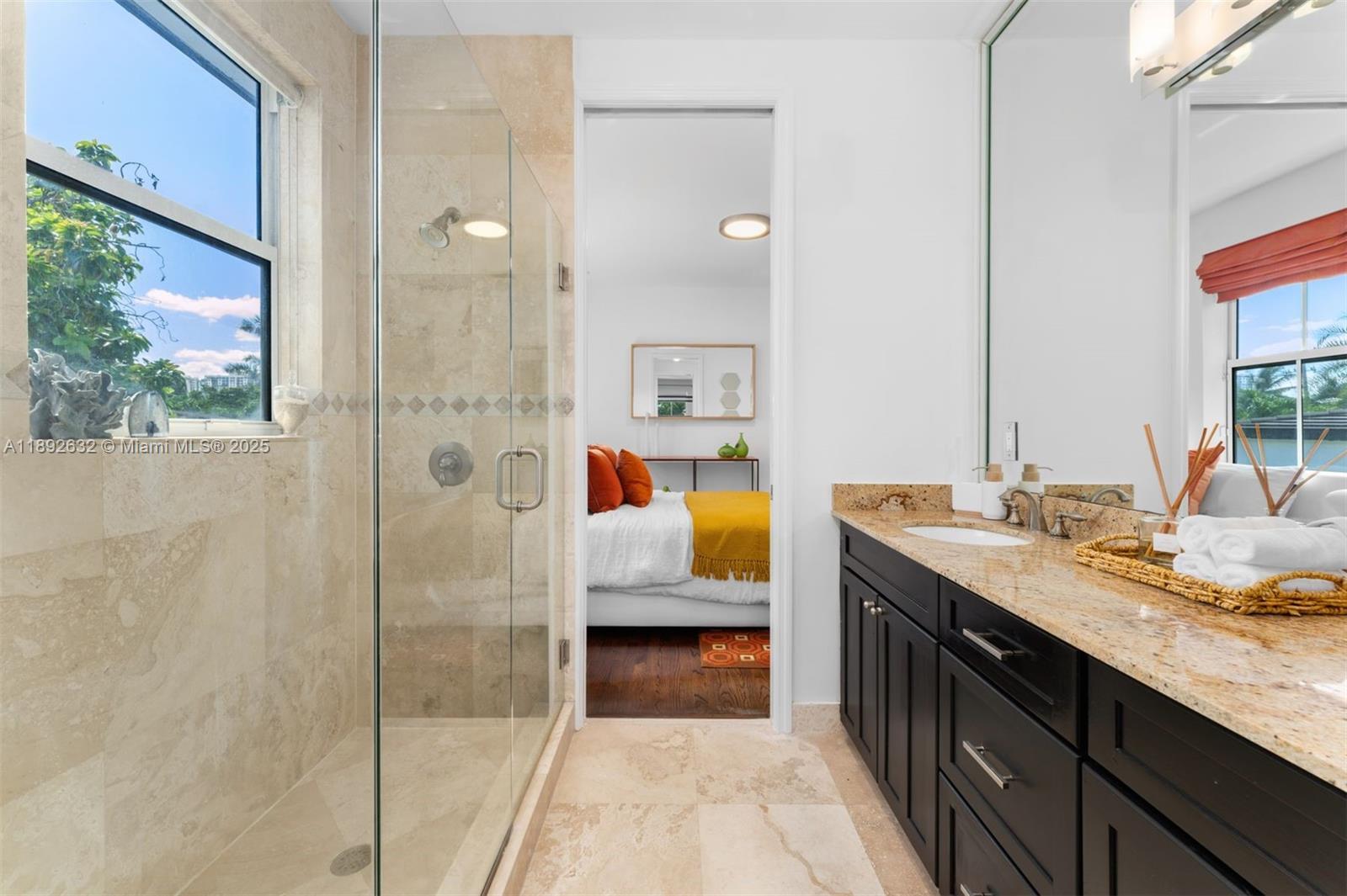 2143 North Bay Road Miami Beach, FL 33140 - Photo 30 of 39 a en suite bathroom with a granite countertop sink and a mirror