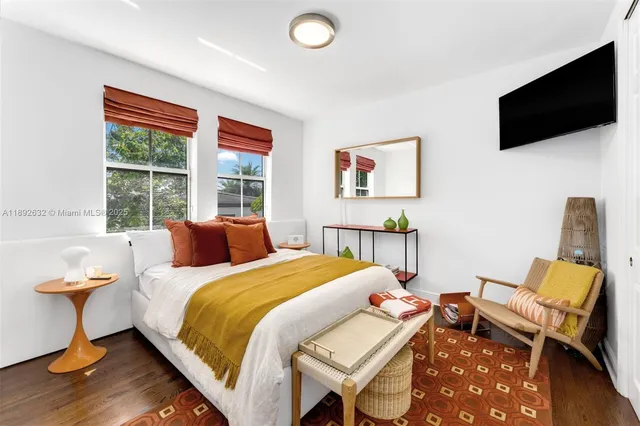 a bedroom with a bed and a large window