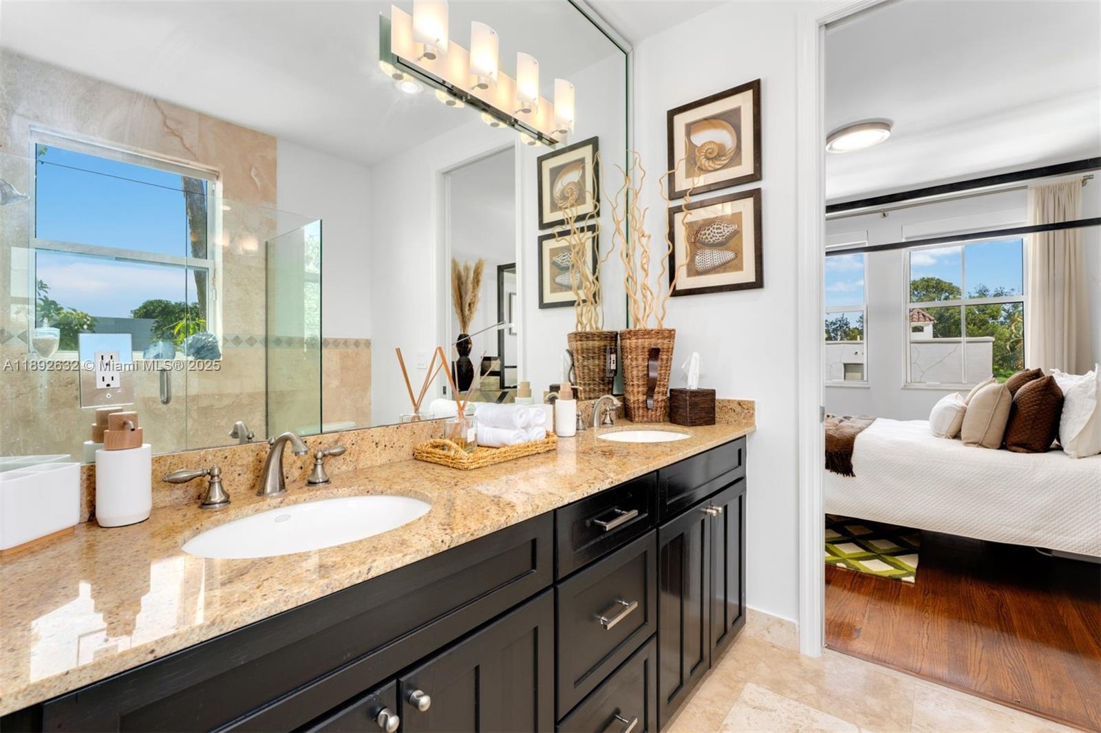 2143 North Bay Road Miami Beach, FL 33140 - Photo 33 of 39 a en suite bathroom with double vanity sinks double vanity and a mirror