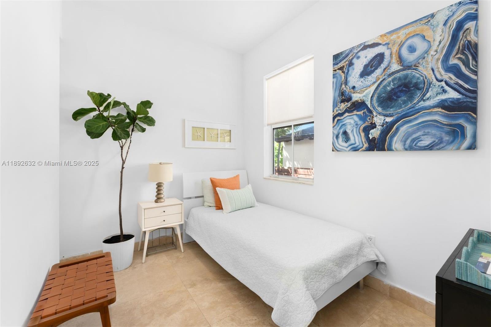 2143 North Bay Road Miami Beach, FL 33140 - Photo 36 of 39 a bedroom with a bed and a potted plant