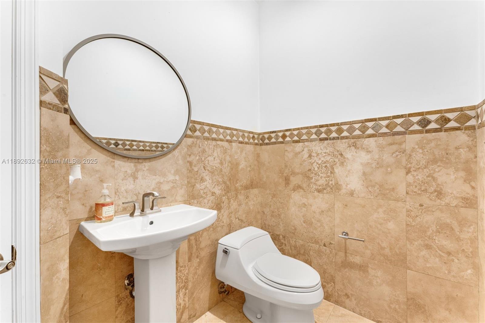 2143 North Bay Road Miami Beach, FL 33140 - Photo 39 of 39 a bathroom with a sink a toilet and a mirror