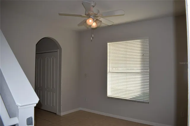 a view of a livingroom with a ceiling fan and window