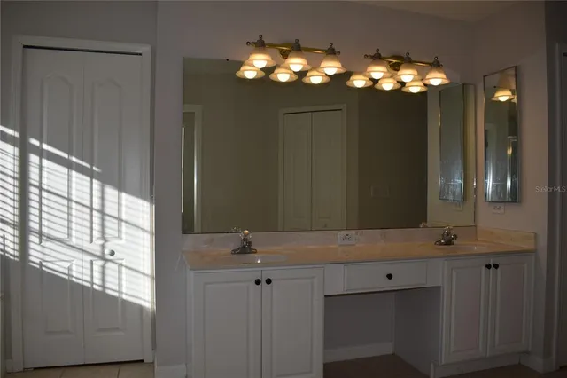 a bathroom with a sink vanity and mirror