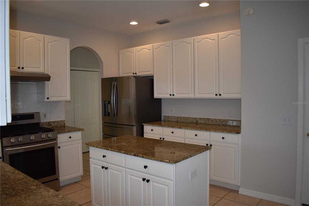 15509 Montilla Loop Tampa, FL 33625 - Photo 5 of 20 a kitchen with granite countertop a sink stove and refrigerator