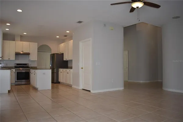 a kitchen with a refrigerator and a stove top oven
