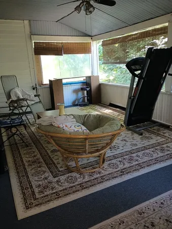 a bed sitting in a room next to a window
