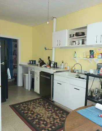 a kitchen with a sink stove and cabinets