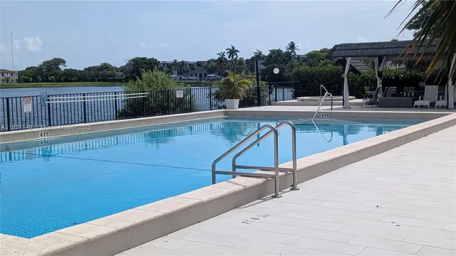 a view of a swimming pool with a lounge chair