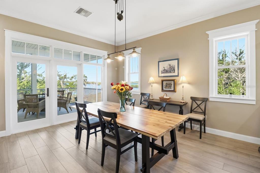 14211 West St Martins Road Crystal River, FL 34429 - Photo 12 of 60 a view of a dining room with furniture window and wooden floor