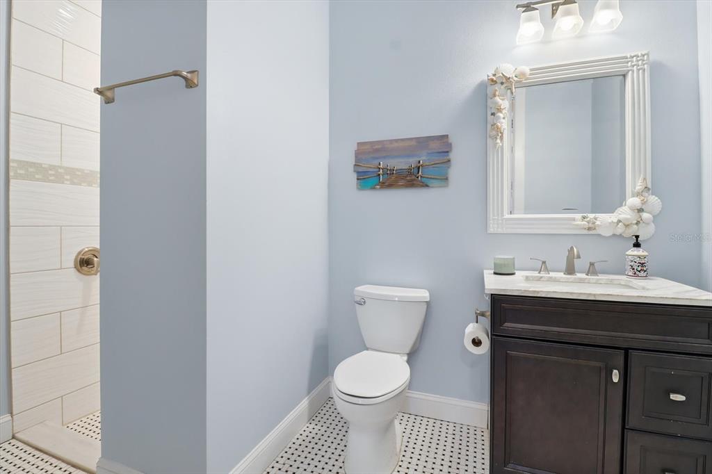 14211 West St Martins Road Crystal River, FL 34429 - Photo 20 of 60 a bathroom with a toilet a sink and mirror