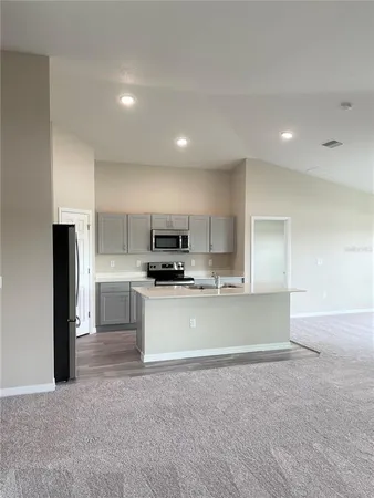 a kitchen with stainless steel appliances a refrigerator a stove a sink a microwave and cabinets