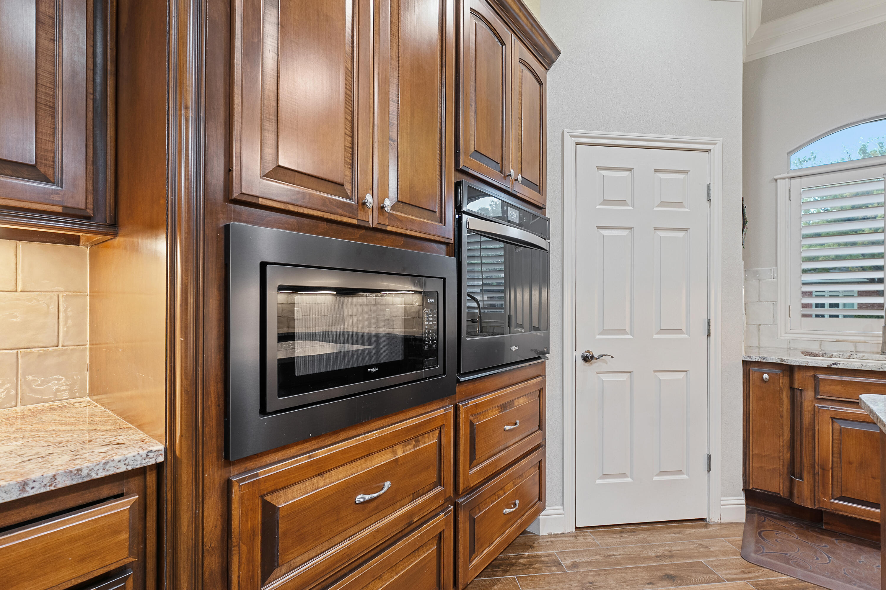 7502 Norfolk Avenue Lubbock, TX 79423 - Photo 12 of 41 a kitchen with granite countertop cabinets stainless steel appliances and a window