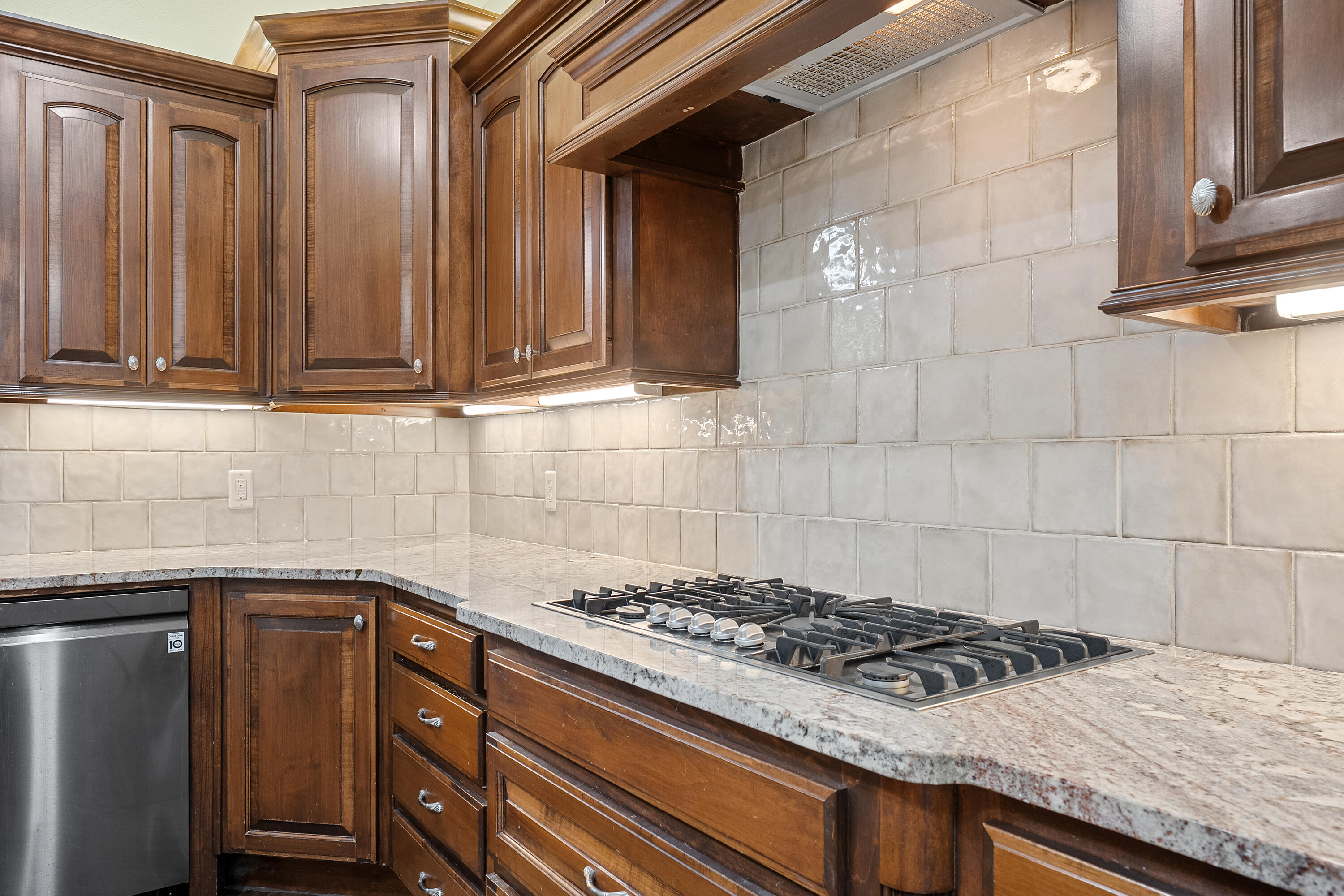 7502 Norfolk Avenue Lubbock, TX 79423 - Photo 13 of 41 a kitchen with granite countertop a stove and a sink