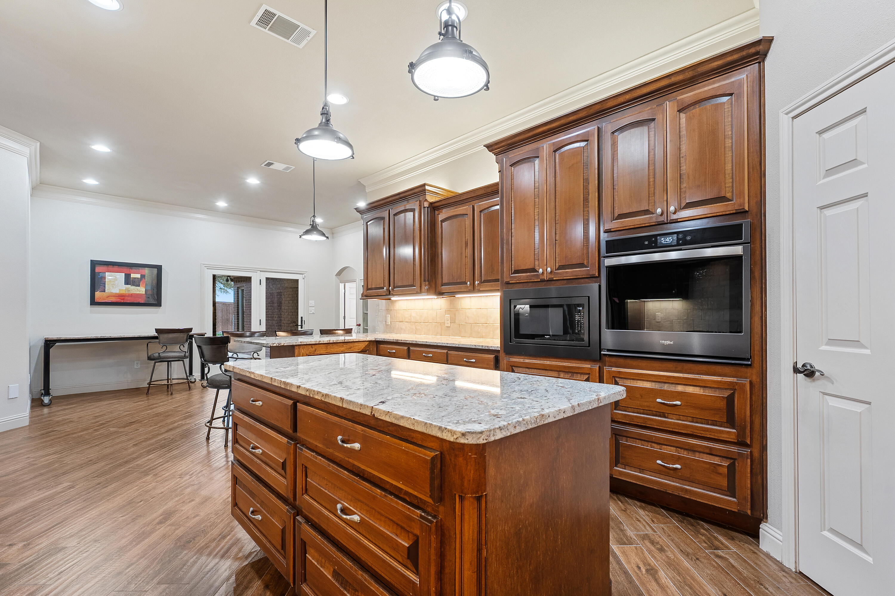 7502 Norfolk Avenue Lubbock, TX 79423 - Photo 14 of 41 a kitchen with a stove center island cabinets and furniture