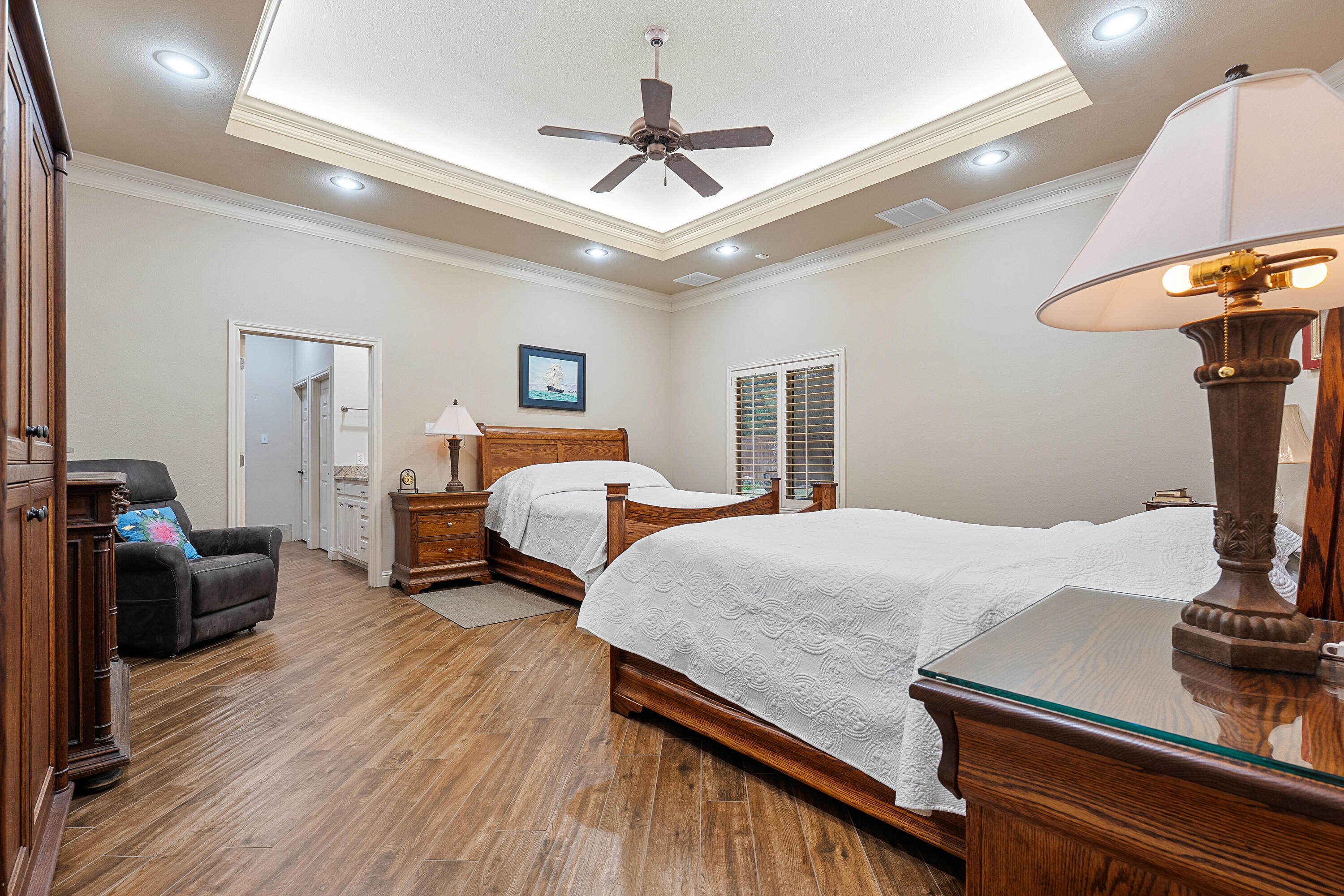 7502 Norfolk Avenue Lubbock, TX 79423 - Photo 19 of 41 a bedroom with a bed and a chandelier