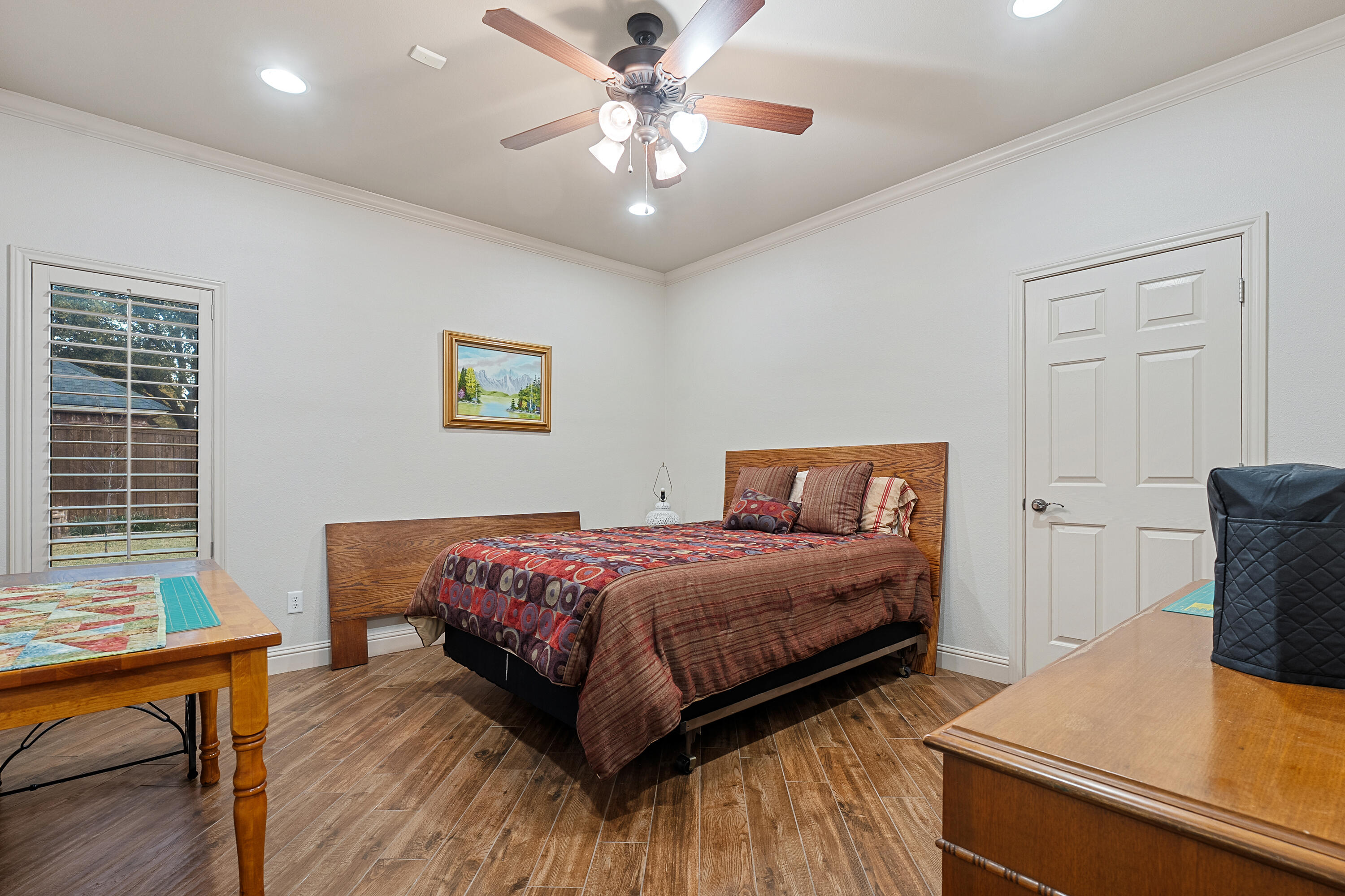 7502 Norfolk Avenue Lubbock, TX 79423 - Photo 25 of 41 a bedroom with a bed and wooden floor