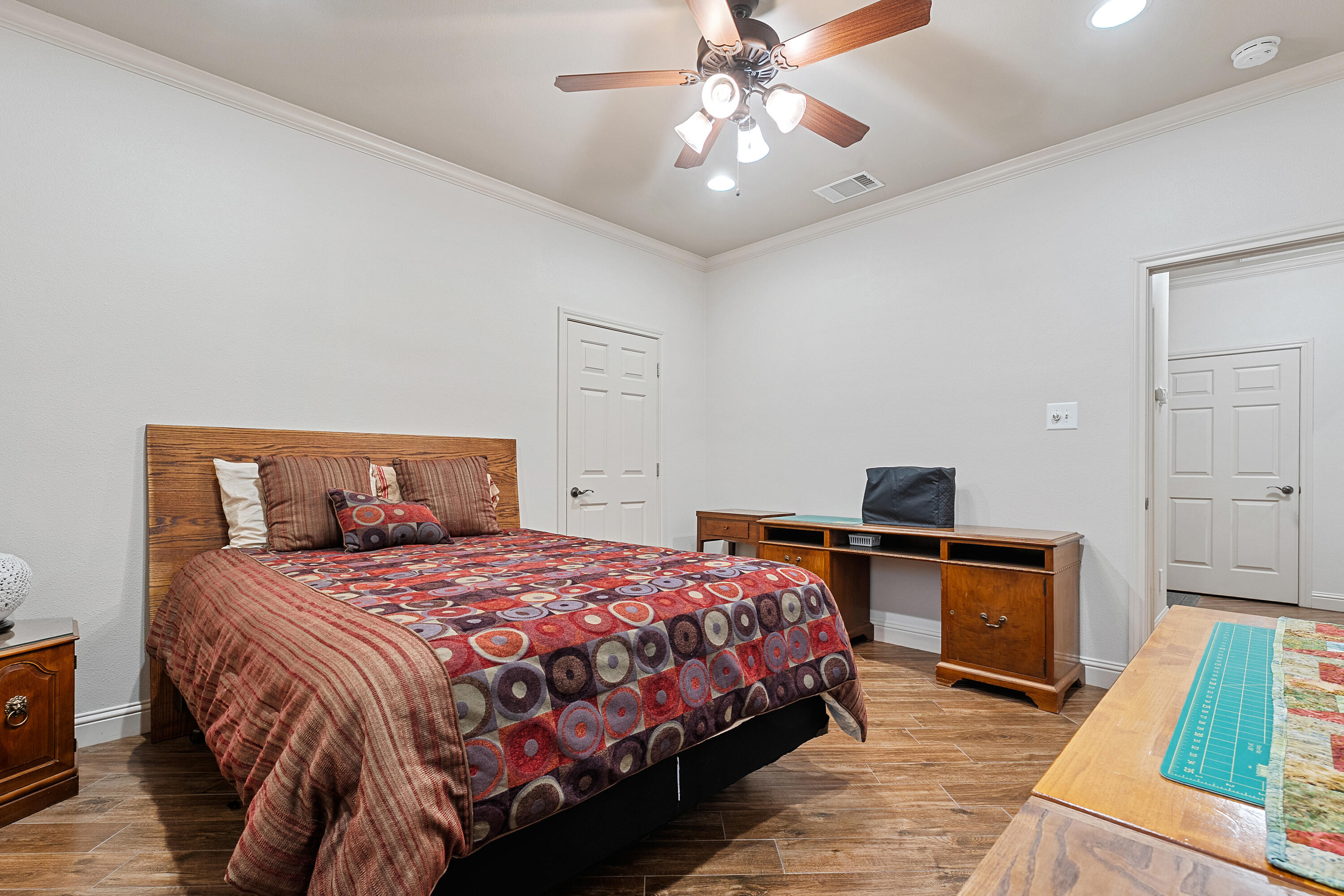 7502 Norfolk Avenue Lubbock, TX 79423 - Photo 26 of 41 a bedroom with a bed and a fireplace