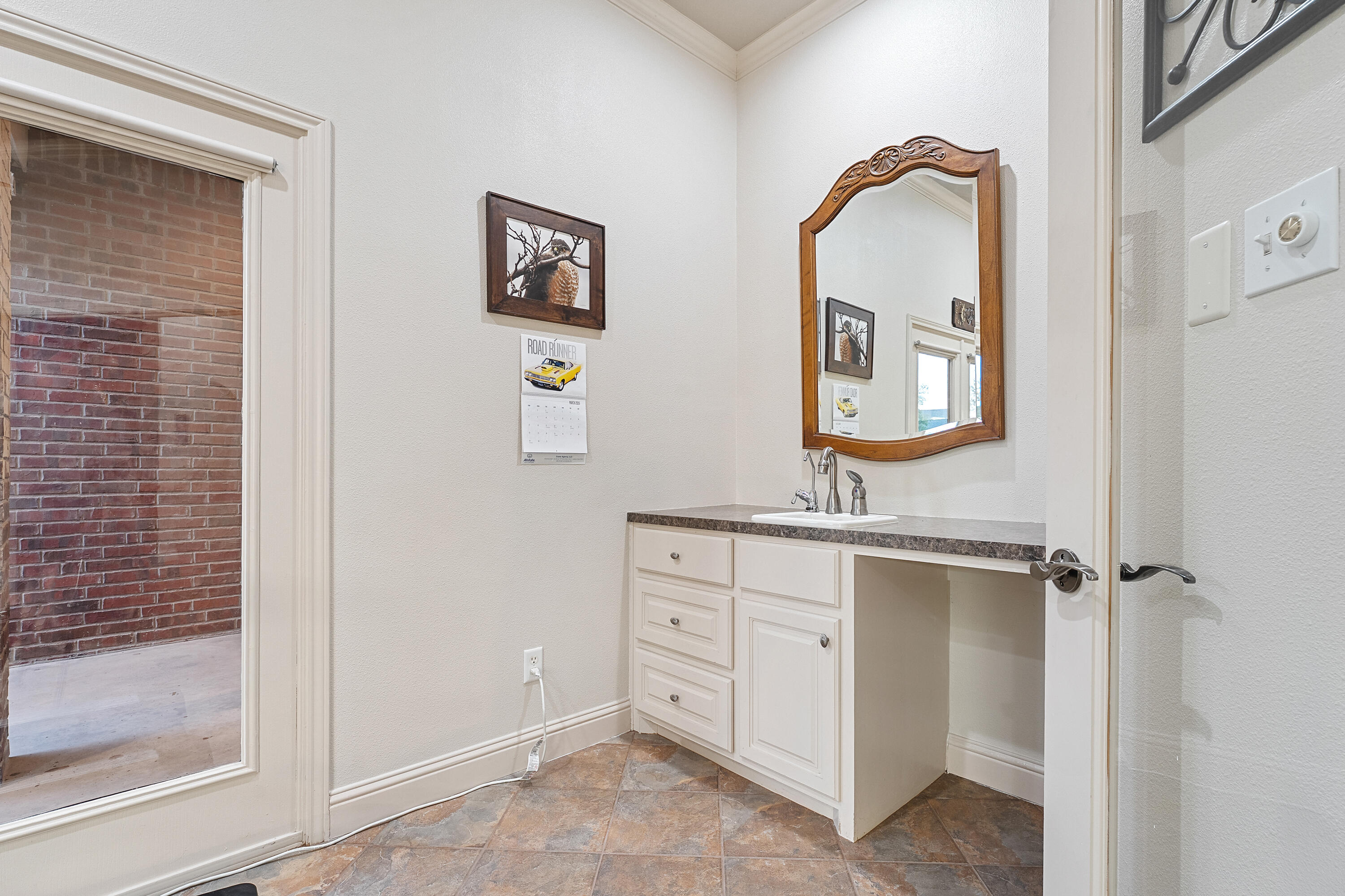 7502 Norfolk Avenue Lubbock, TX 79423 - Photo 31 of 41 a bathroom with a sink a mirror and a vanity