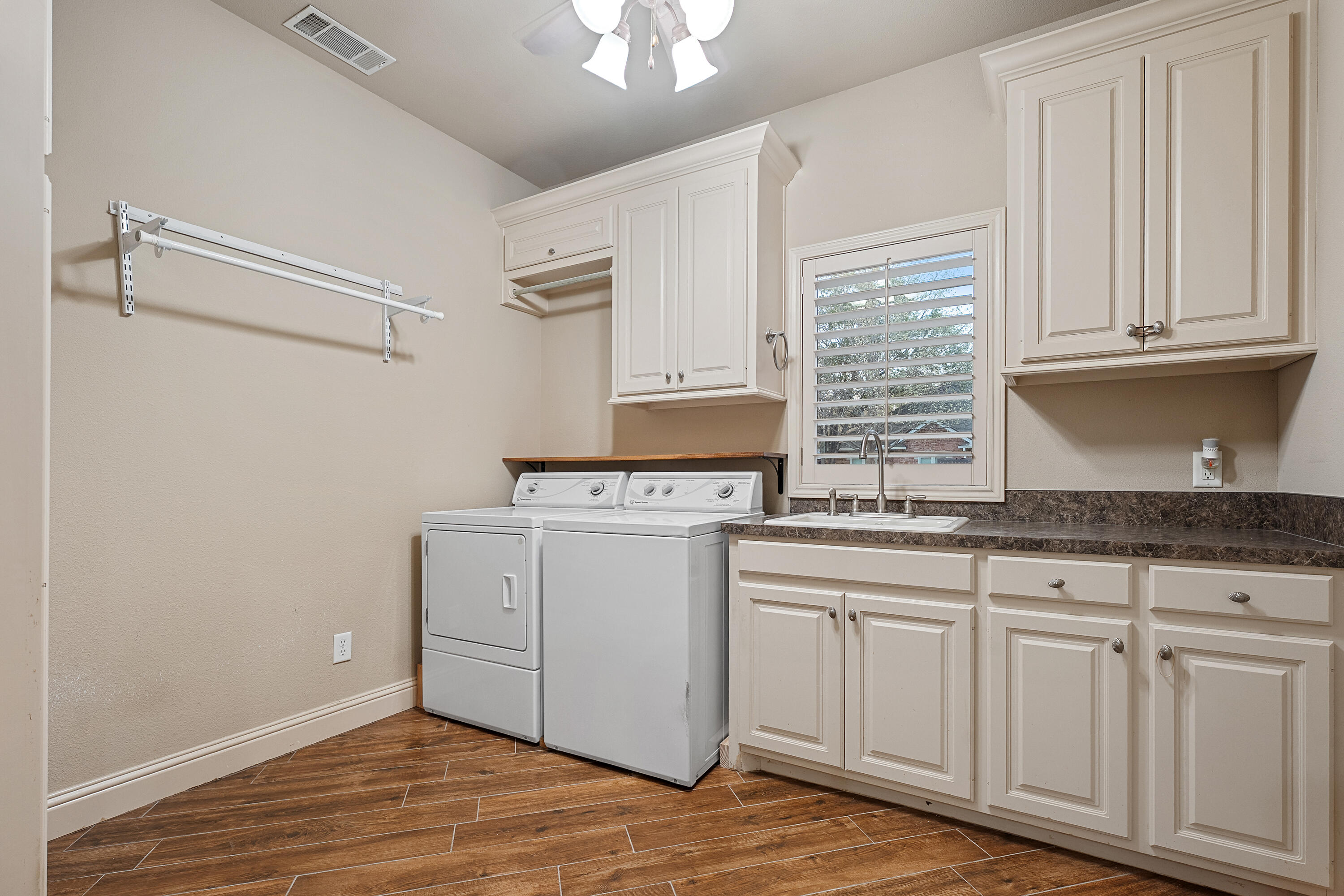 7502 Norfolk Avenue Lubbock, TX 79423 - Photo 32 of 41 a kitchen with granite countertop white cabinets and white appliances