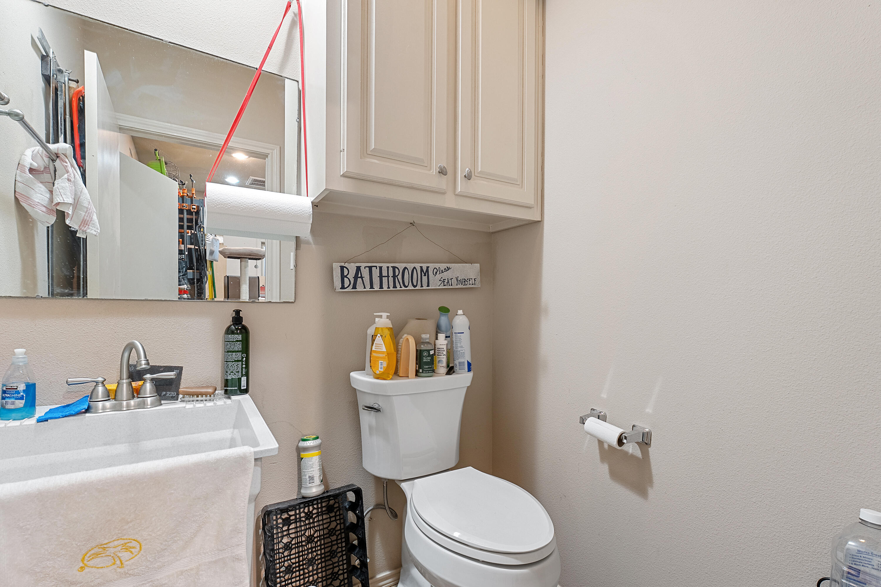 7502 Norfolk Avenue Lubbock, TX 79423 - Photo 35 of 41 a white toilet sitting next to a bathroom sink