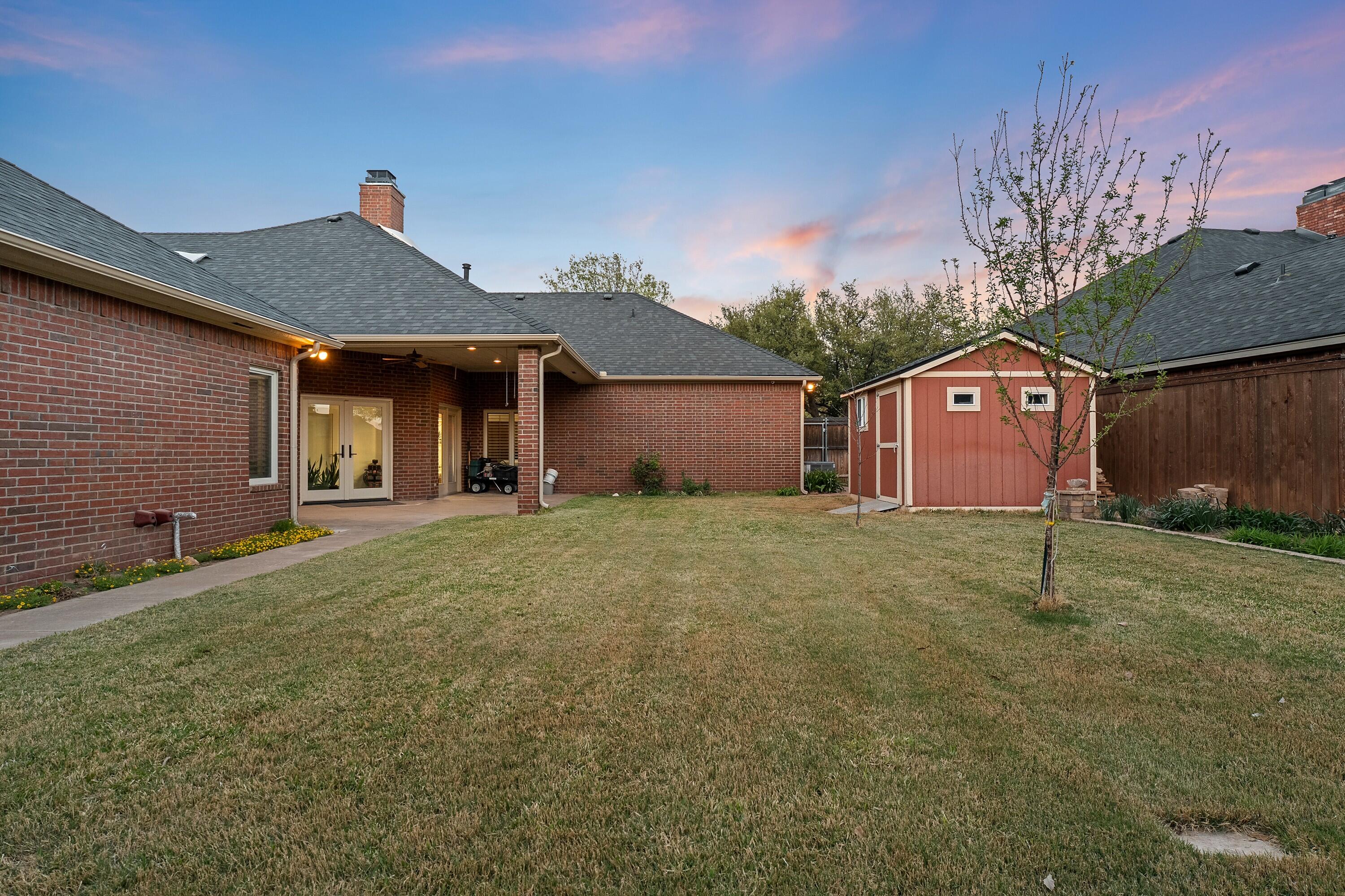 7502 Norfolk Avenue Lubbock, TX 79423 - Photo 39 of 41 a front view of a house with a garden