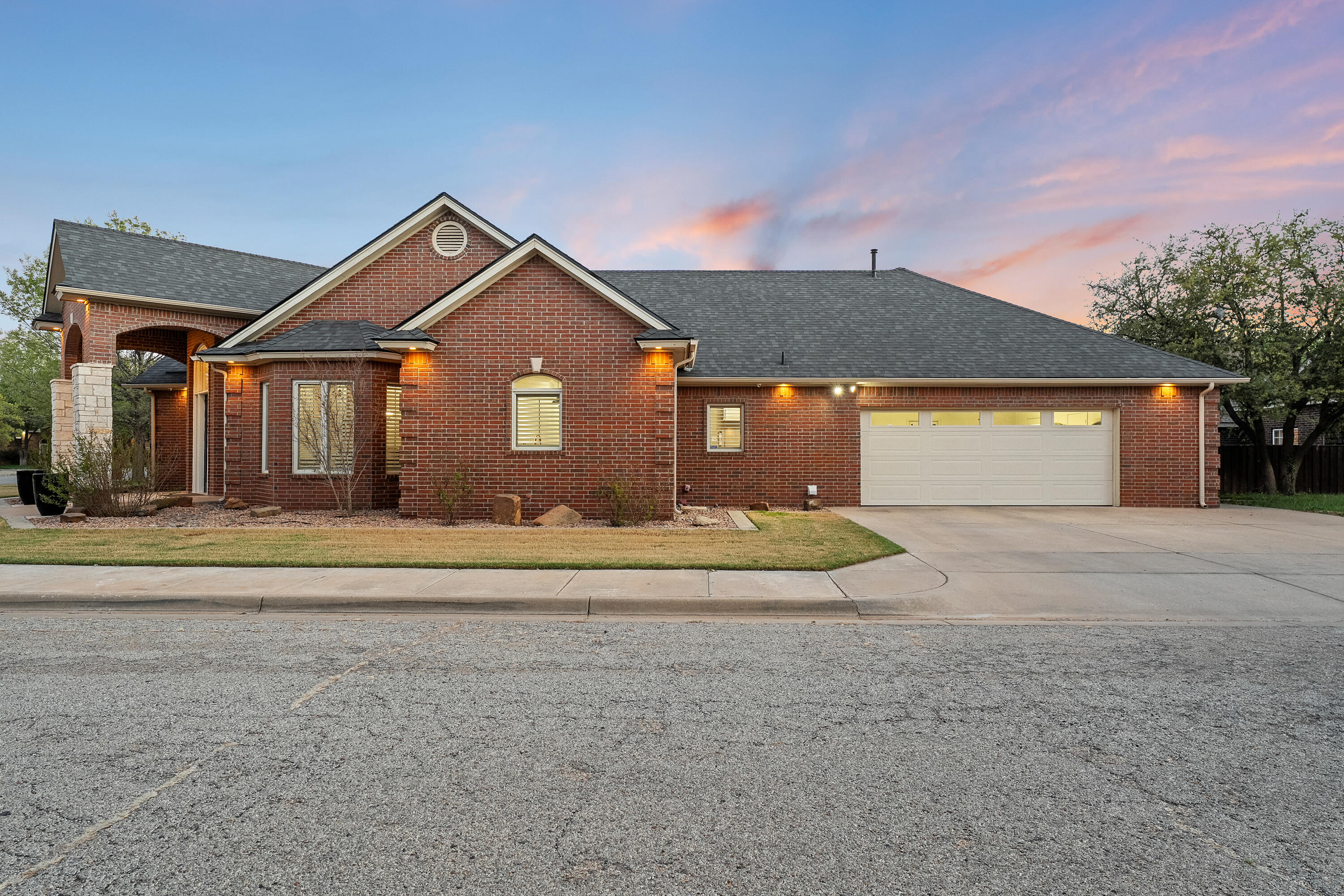 7502 Norfolk Avenue Lubbock, TX 79423 - Photo 41 of 41 a front view of a house with a yard and garage