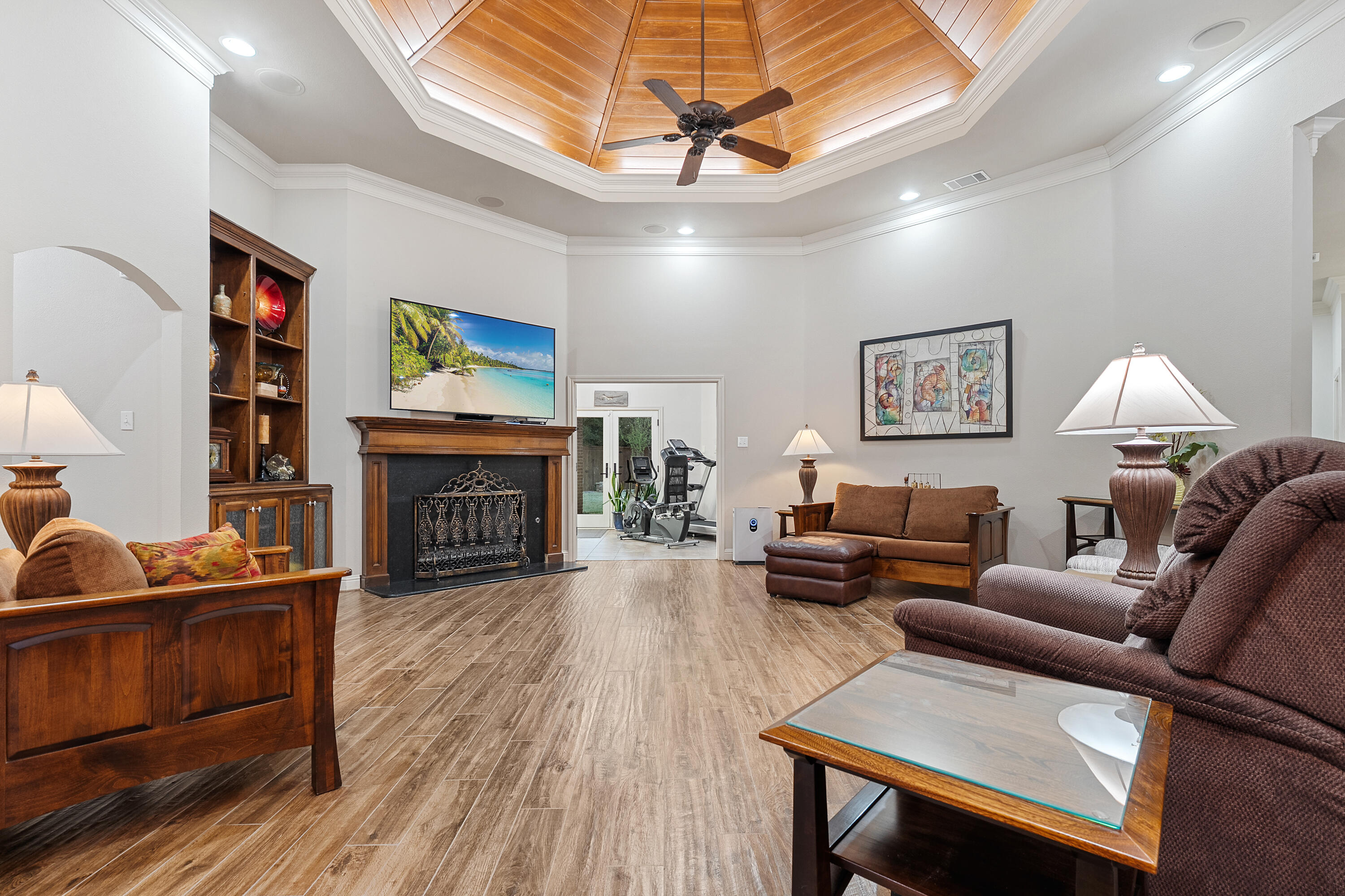 7502 Norfolk Avenue Lubbock, TX 79423 - Photo 6 of 41 a living room with furniture a fireplace and a flat screen tv