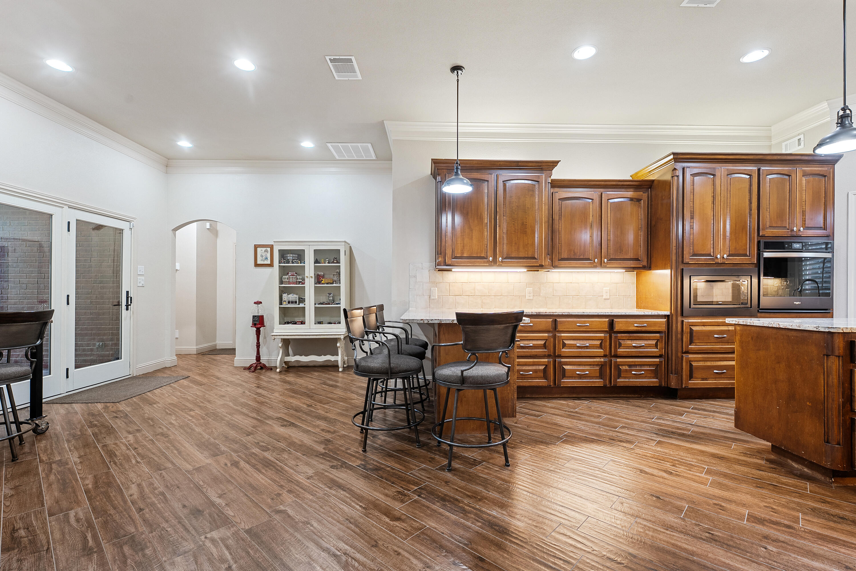 7502 Norfolk Avenue Lubbock, TX 79423 - Photo 10 of 41 a living room with furniture a wooden floor and next to a window