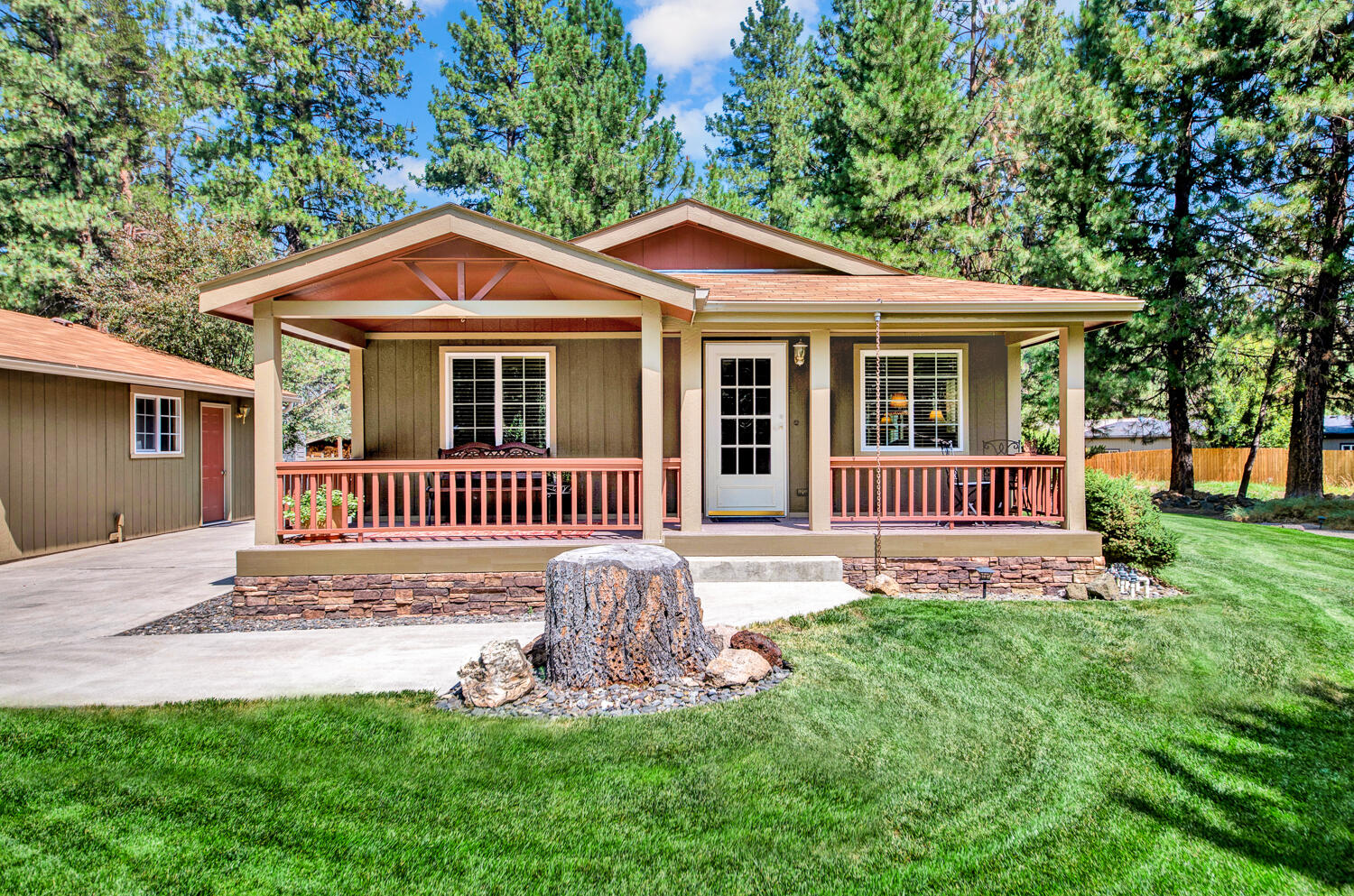 19166 Choctaw Road Bend, OR 97702 - Photo 1 of 23 a front view of a house with a yard and deck