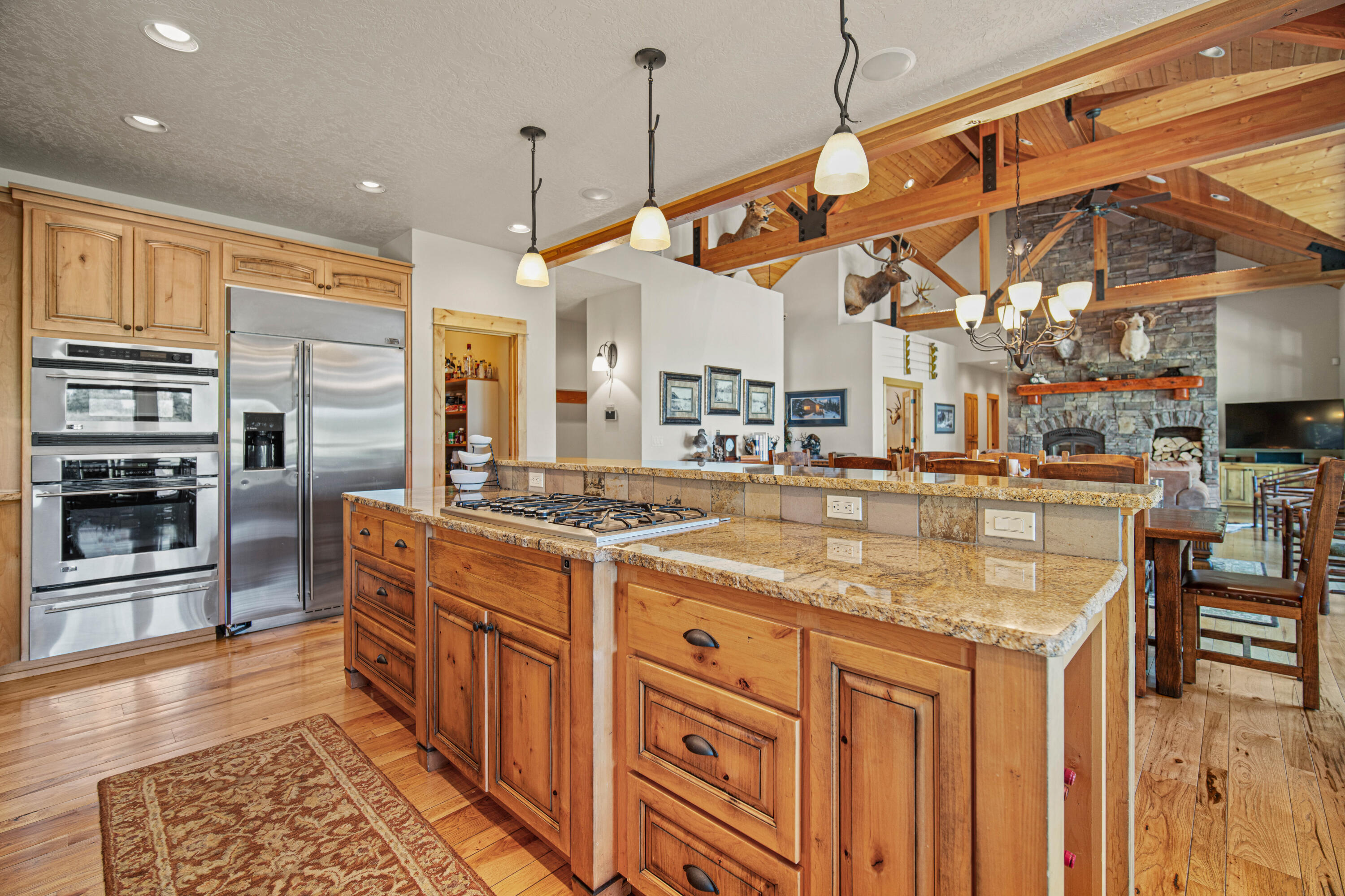 56689 Dancing Rock Loop Bend, OR 97707 - Photo 14 of 51 a kitchen with stainless steel appliances granite countertop a sink and cabinets