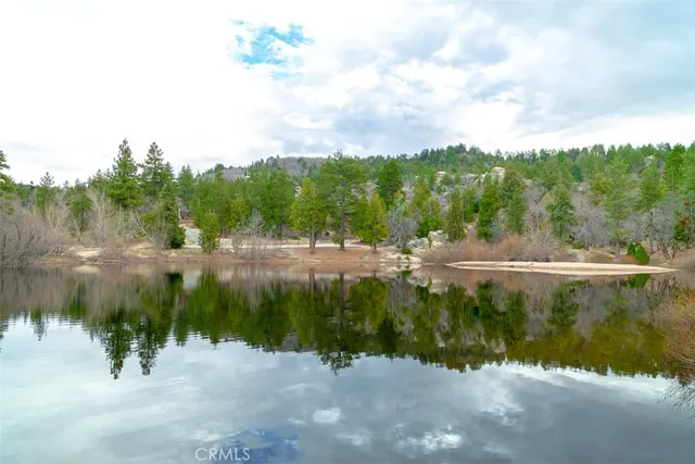 a view of a house with a yard covered in snow