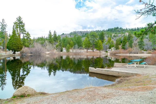 a view of a patio with couches and table and chairs under an umbrella