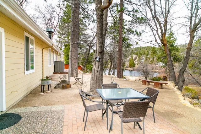 a backyard of a house with yard and outdoor seating