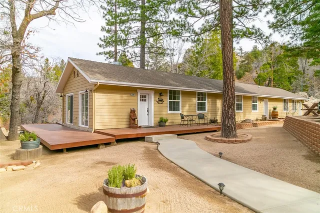 a view of house with backyard and sitting area
