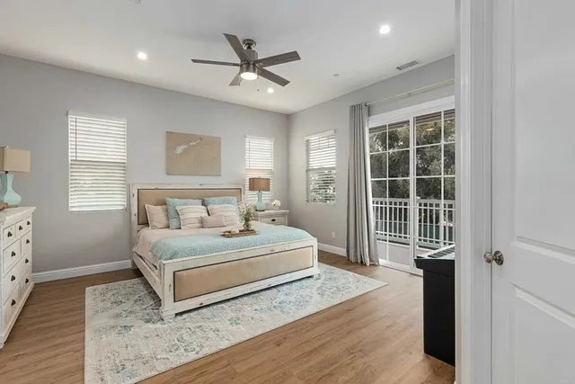 a spacious bedroom with a large bed and a chandelier
