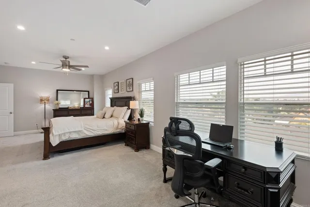 a living room with furniture and large windows