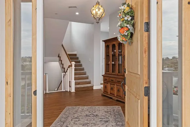 a view of entryway and hall with wooden floor