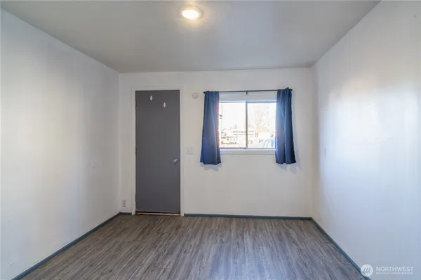 a kitchen with a sink a refrigerator and cabinets