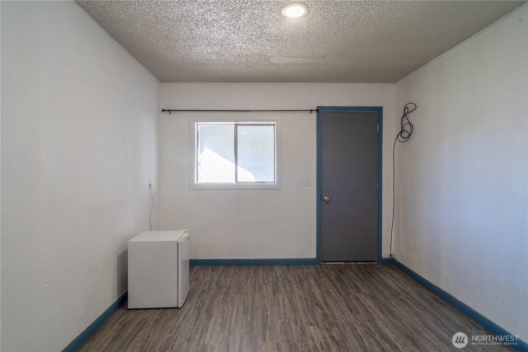 407 West 1st Avenue Ritzville, WA 99169 - Photo 13 of 26 an empty room with wooden floor and windows