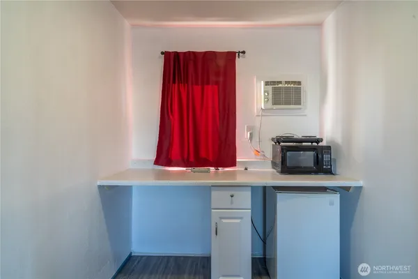 a kitchen with a refrigerator and cabinets