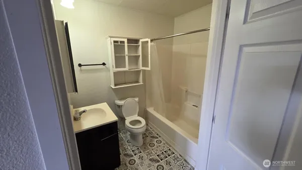 a bathroom with a toilet sink and tub