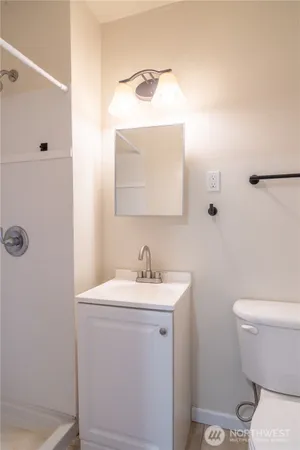 a bathroom with a sink toilet and mirror