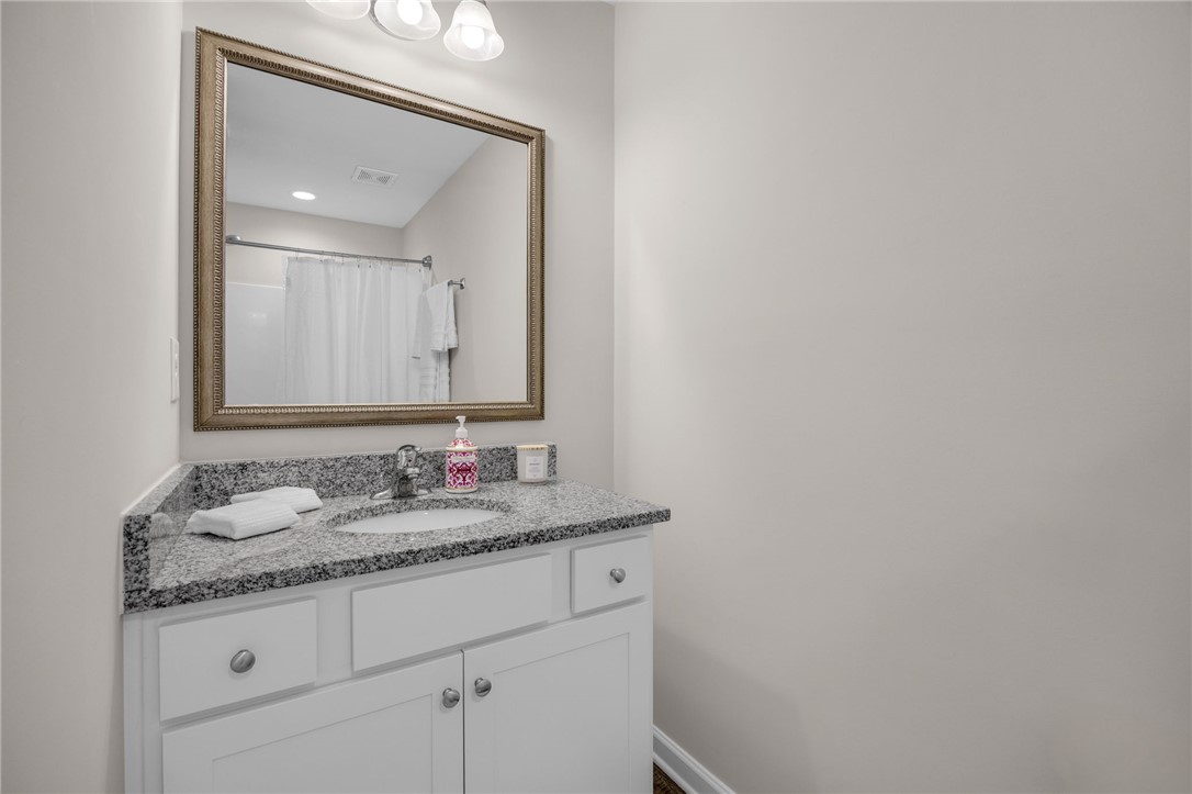 430 Johnson Road Central, SC 29630 - Photo 22 of 36 Granite counters and a framed mirror add a touch of elegance to this pristine bathroom vanity.