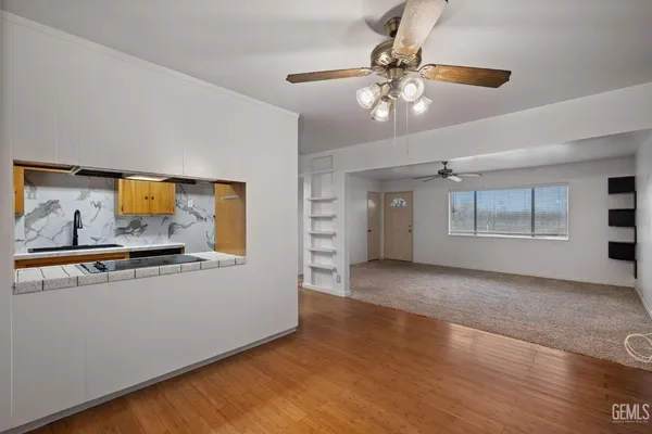 a view of a livingroom with a furniture wooden floor and chandelier