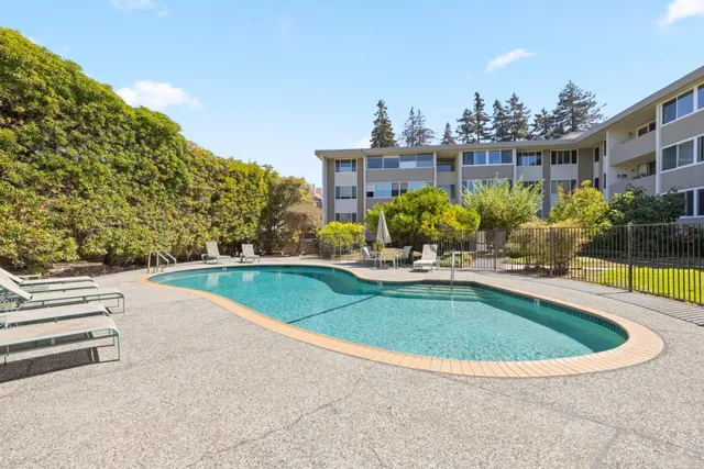 a view of a swimming pool with a yard