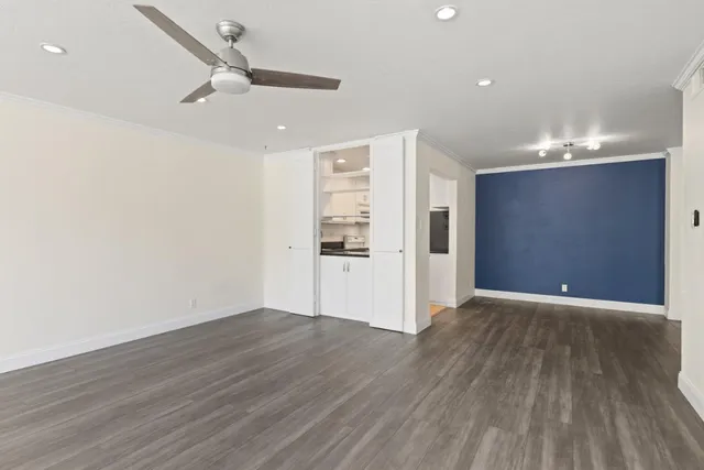 a view of an empty room with wooden floor